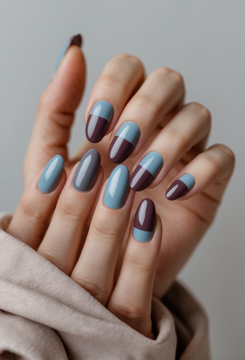 Close-up of hands with two-tone dusty blue and plum color block nails.
