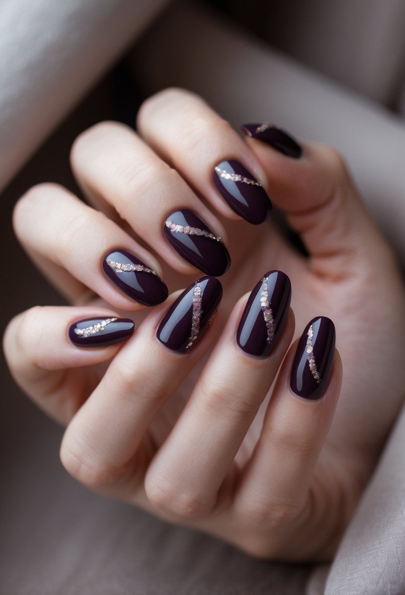 Close-up of a hand with dark plum colored nails featuring a drip design and subtle sparkles.