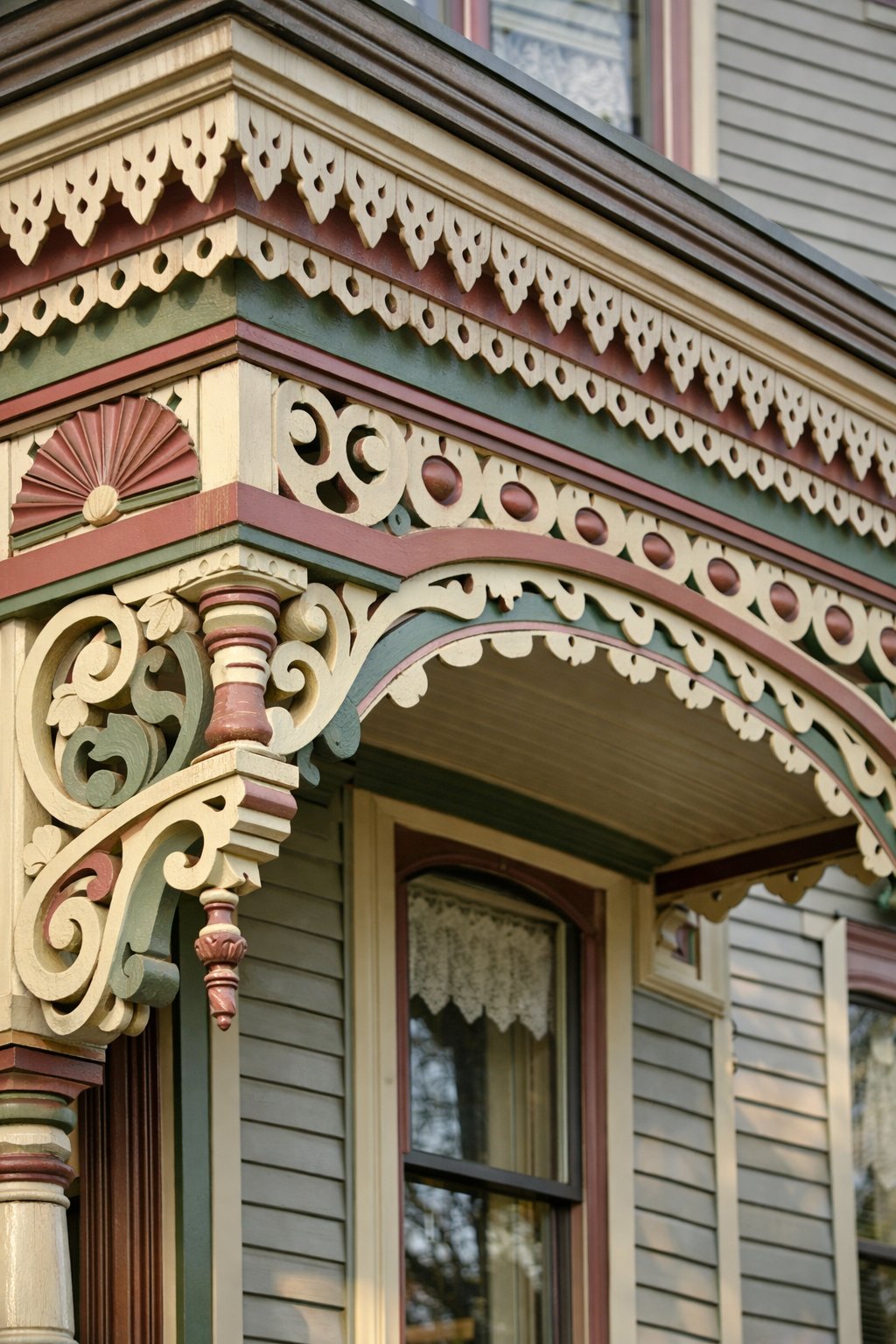 Close-up view of a house exterior featuring detailed wooden trim and decorative brackets under natural daylight.