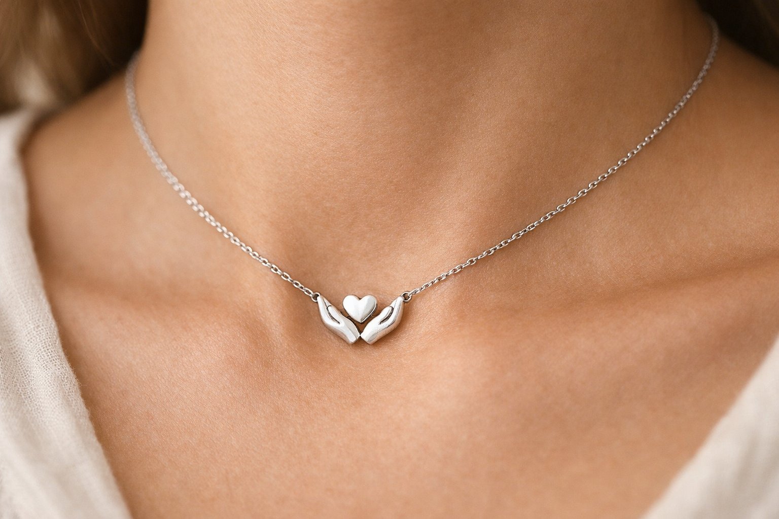 Close-up of a necklace with a small pendant resting on a person's collarbone.