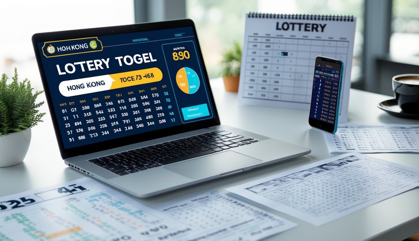 Meja kerja dengan laptop, ponsel, dan kertas berisi data angka untuk prediksi togel Hong Kong.