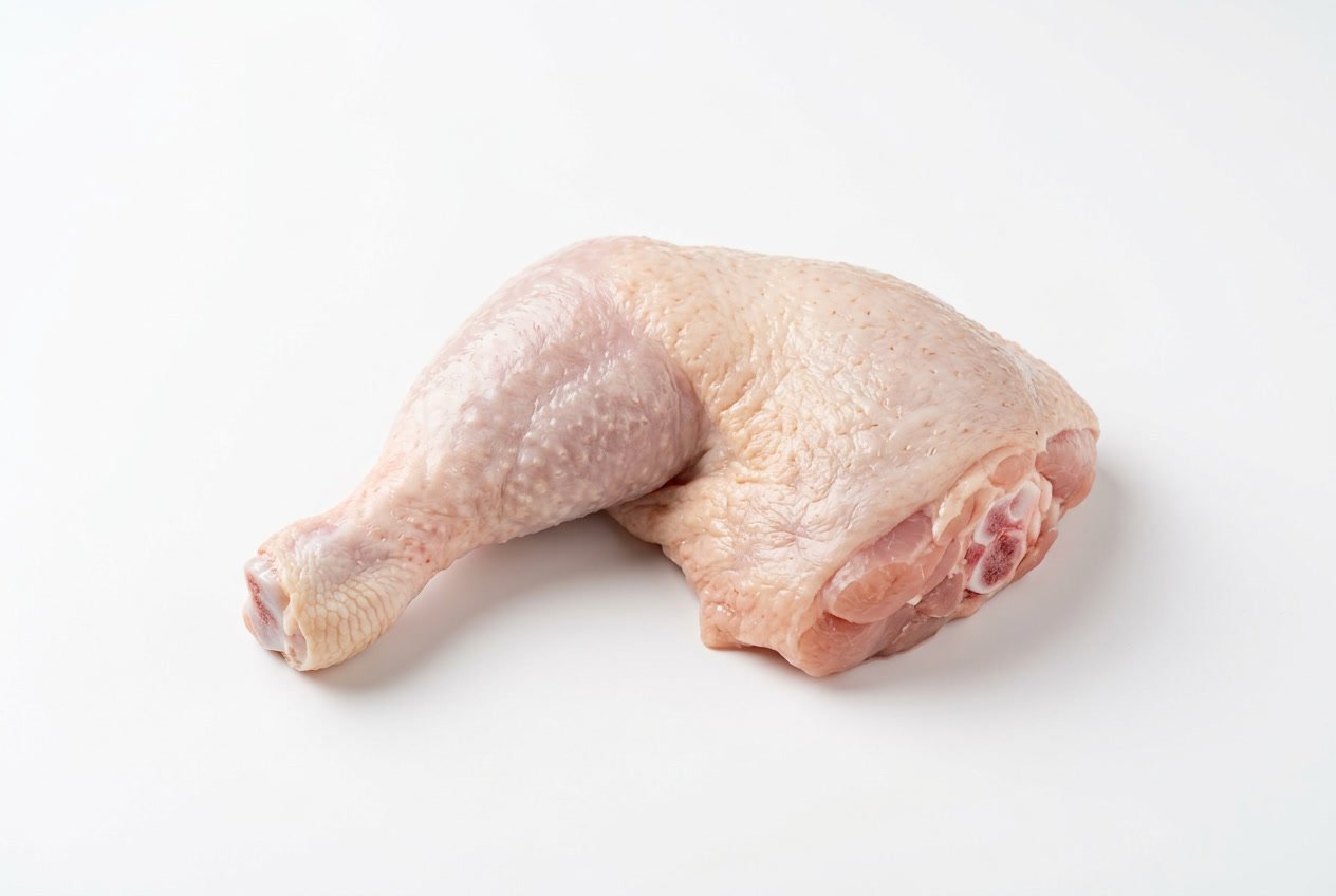 A raw chicken leg piece displayed on a white background.