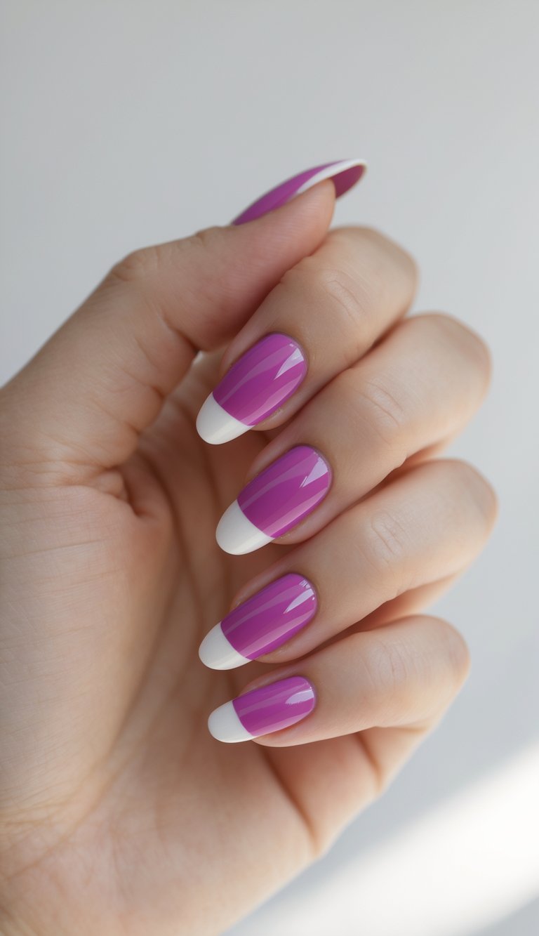 Close-up of one hand with short magenta French manicure nails against a white background.