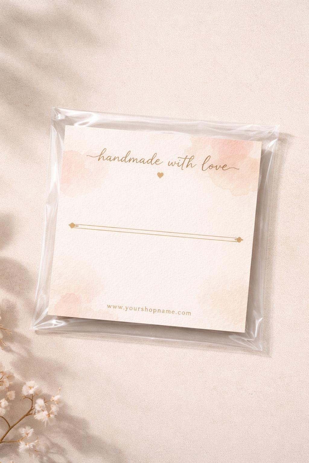 A clear cello bag containing a boutique cardstock backing card, displayed on a neutral surface.