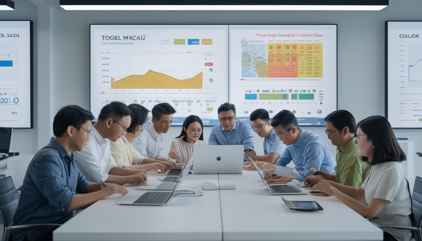 Sekelompok orang Asia Tenggara sedang berdiskusi dan menganalisis data togel menggunakan perangkat digital di sebuah kantor modern.