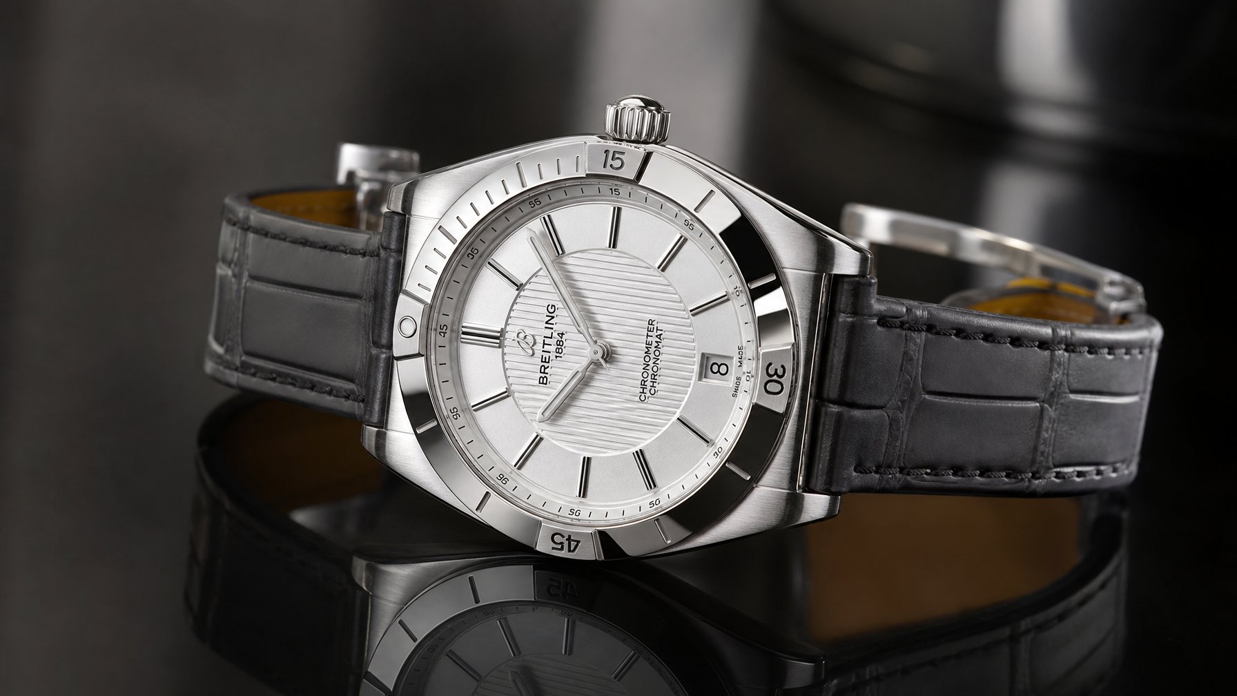 Foto jam tangan Breitling Chronomat Automatic B31 40 2026 dengan desain tipis dan mewah, diletakkan di permukaan gelap yang reflektif.