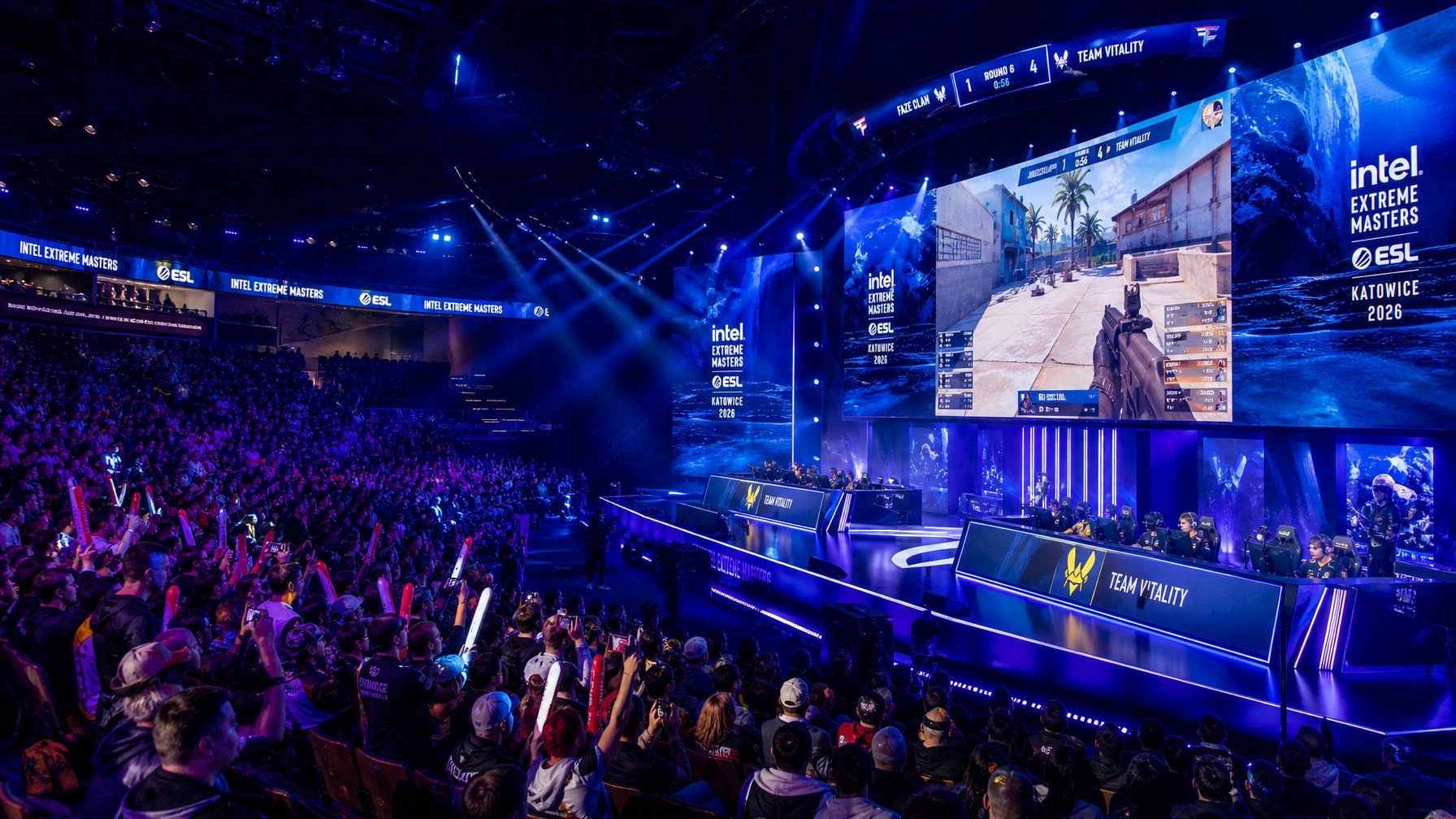 Suasana turnamen esports besar dengan pemain profesional di panggung dan penonton yang antusias di arena.