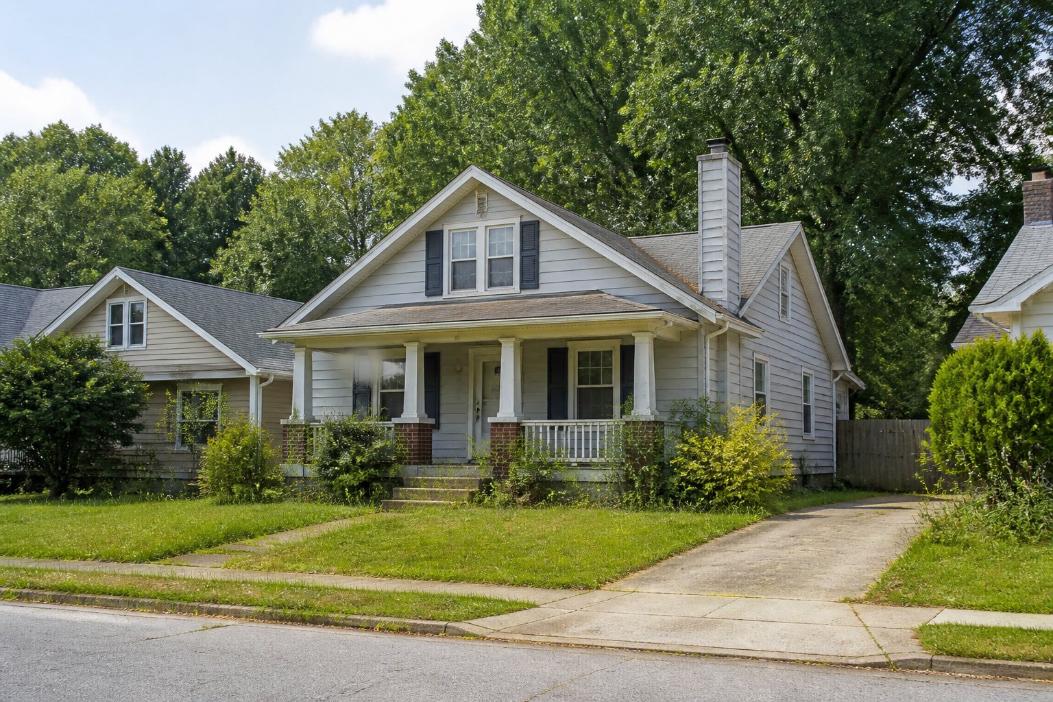 A modest suburban home in Lawrenceville, Georgia, with an unkempt lawn and minor signs of deferred maintenance.