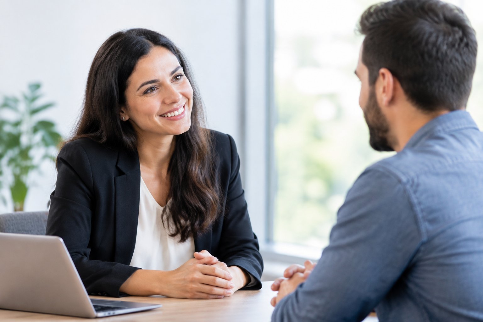 A business professional listens to a customer during a face-to-face conversation.