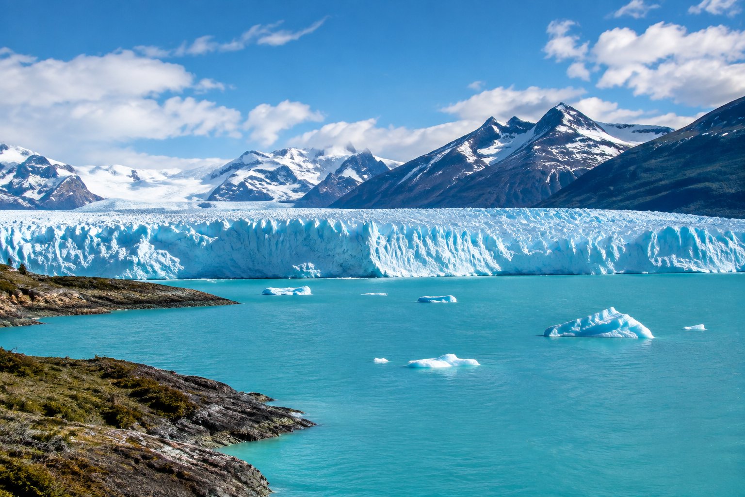A glacier meets the turquoise waters of Lake Argentino beneath the Andes.