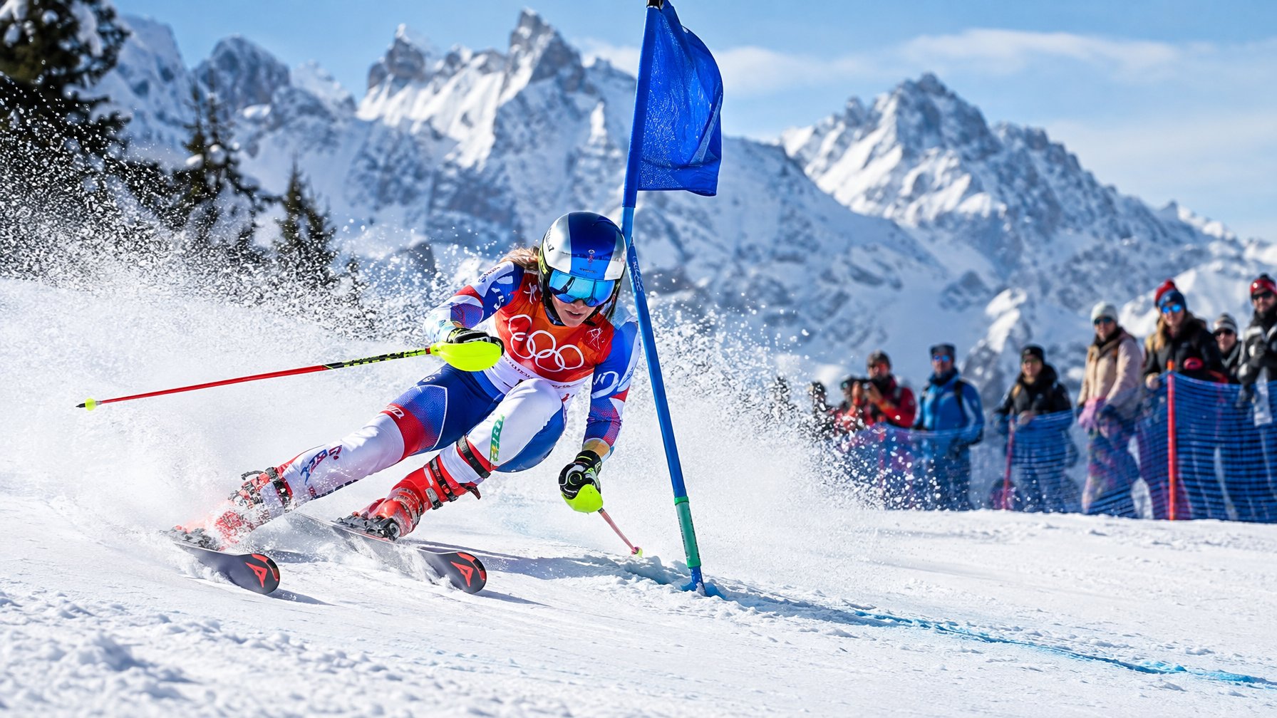 Atlet ski melaju melewati gerbang slalom sementara penonton menyaksikan dari tepi lintasan bersalju.