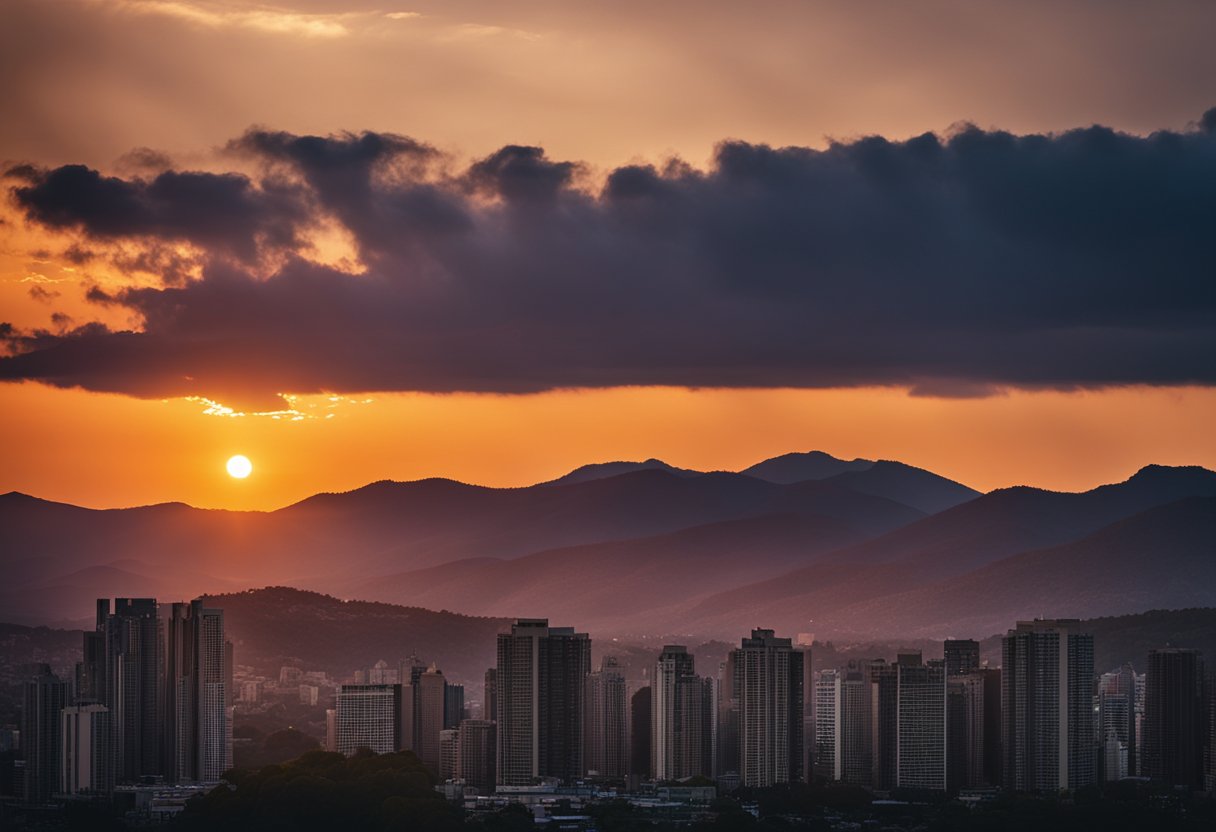 The sun is setting behind the mountains, casting a warm orange glow across the sky. The silhouette of trees and buildings is visible against the fading light