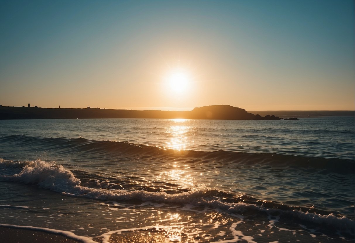 The sun shines brightly over the calm, blue waters of the UK coastline, with gentle waves lapping against the shore. The sea temperature is at its warmest during the summer months, creating the perfect conditions for sea swimming