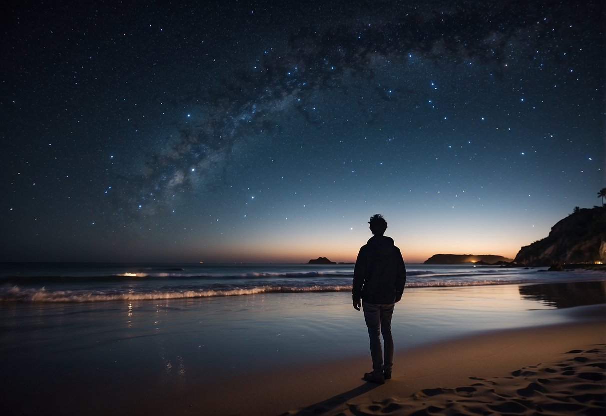 A beach at night with a clear sky, waves gently crashing, and a person using a star map or app to stargaze