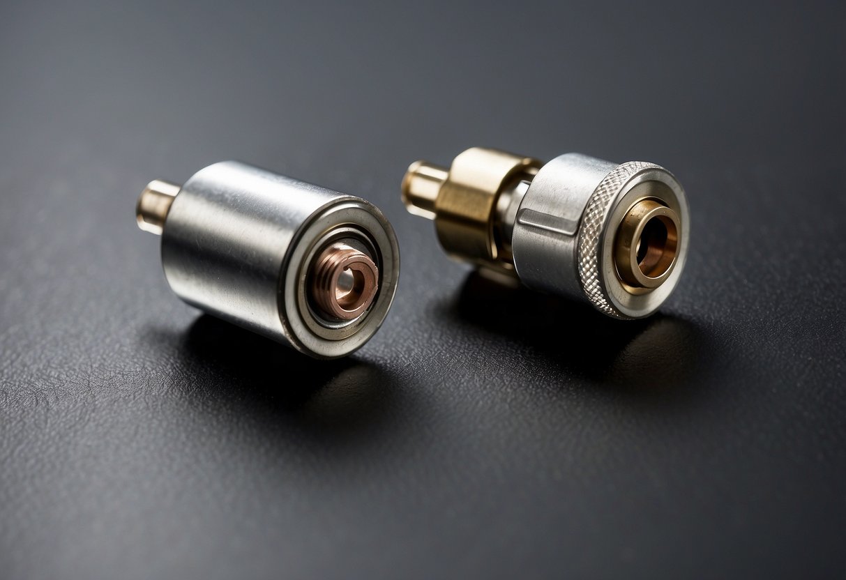 Two car battery terminals, one positive and one negative, made of metal, with a diameter of approximately 0.5 inches