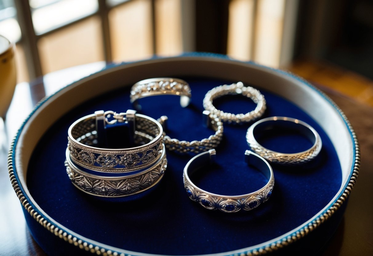 A collection of silver bracelets displayed on a velvet-lined tray, reflecting the light with intricate designs and varying sizes