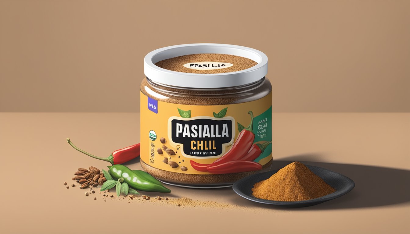 A small container of pasilla chili powder sits on a kitchen counter, surrounded by various spices and ingredients. The container is open, with a few specks of powder scattered on the counter