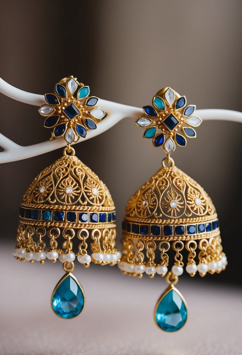 A pair of ornate gold and gemstone earrings, featuring intricate filigree and delicate dangling elements, inspired by traditional Indian bridal jewelry