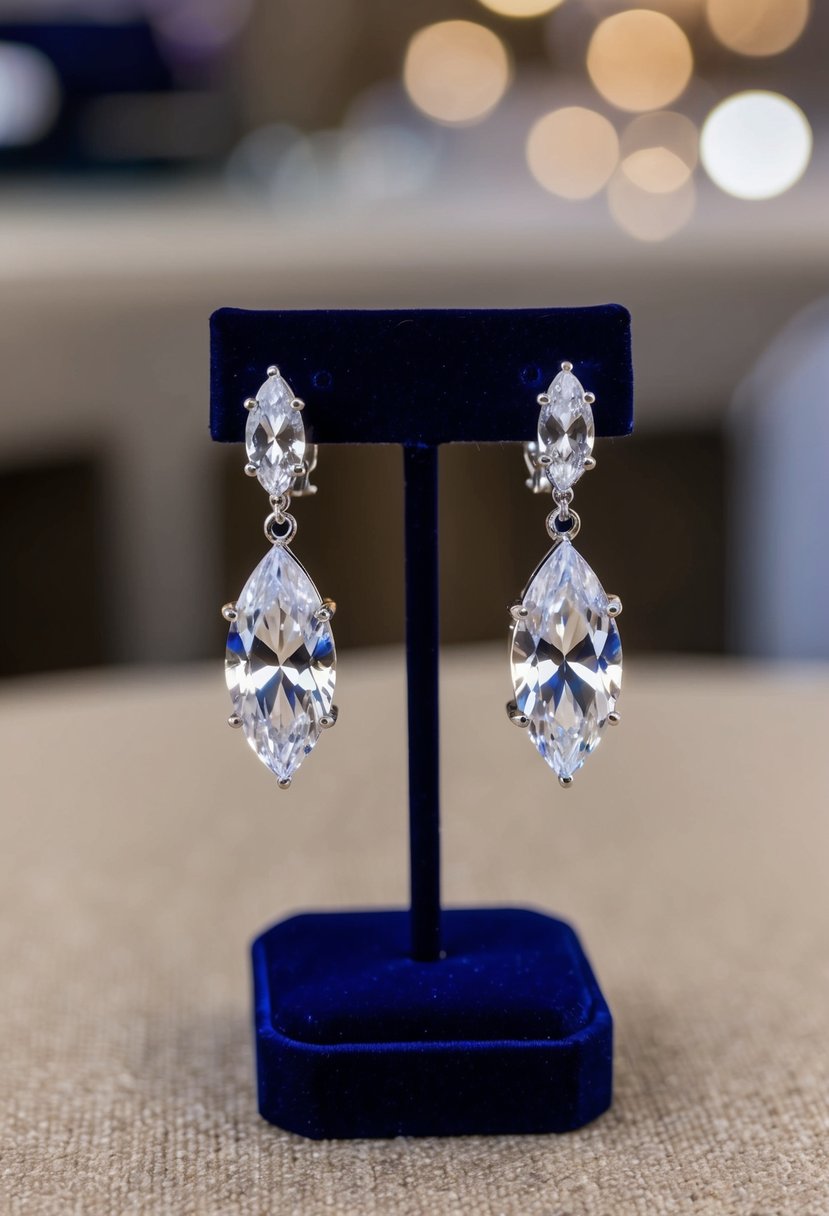 A pair of sparkling cubic zirconia marquise crystal clip-on earrings displayed on a velvet jewelry stand