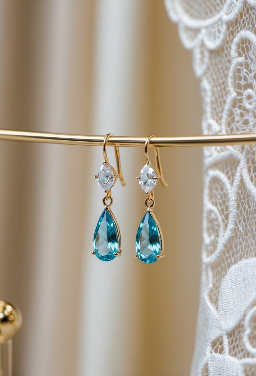 A pair of briolette-cut gemstone earrings dangle from a display, casting a soft sparkle against a backdrop of delicate lace and satin fabric