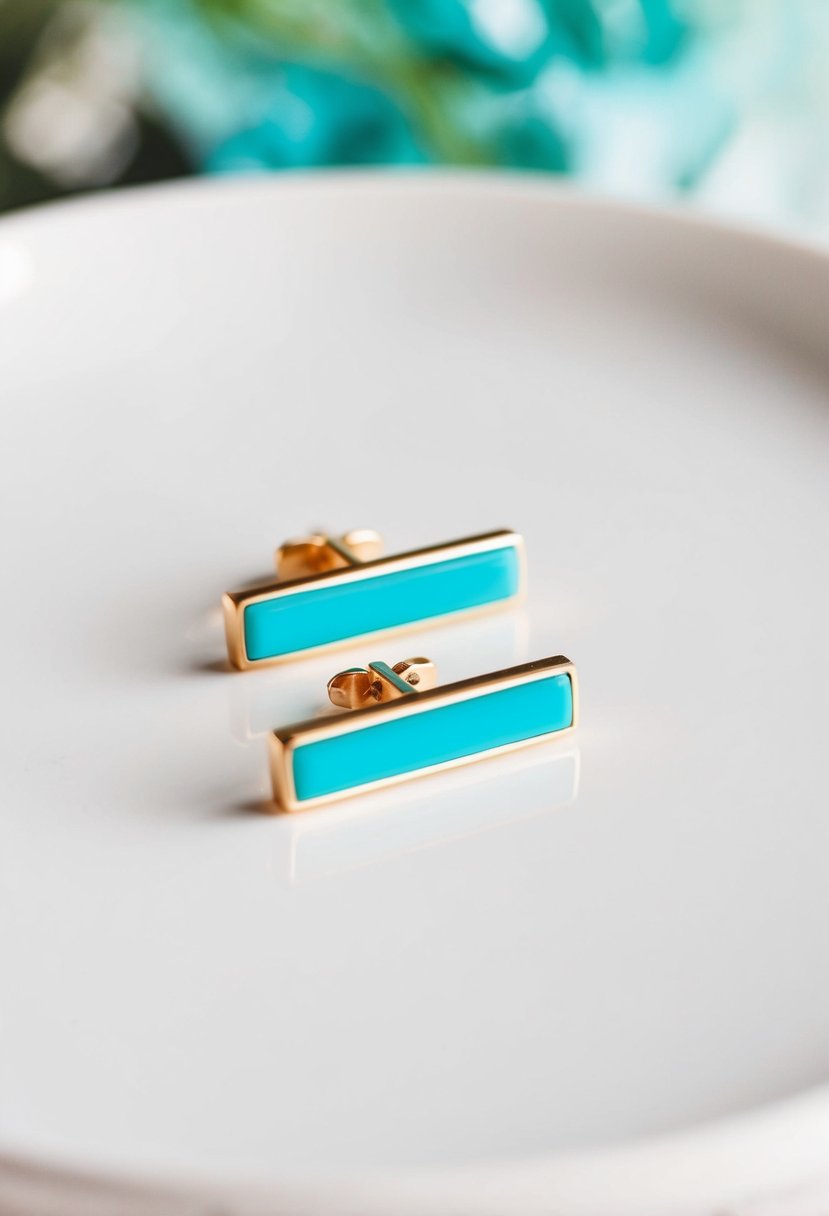 Two small turquoise bar studs on a white background