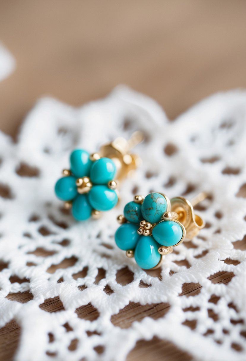 A close-up of delicate turquoise cluster earrings on a white lace background