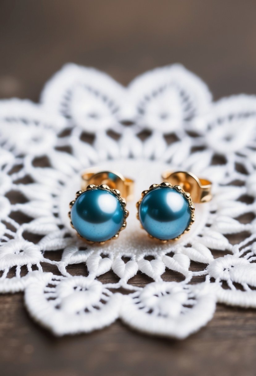 Two delicate blue pearl studs on a white lace background