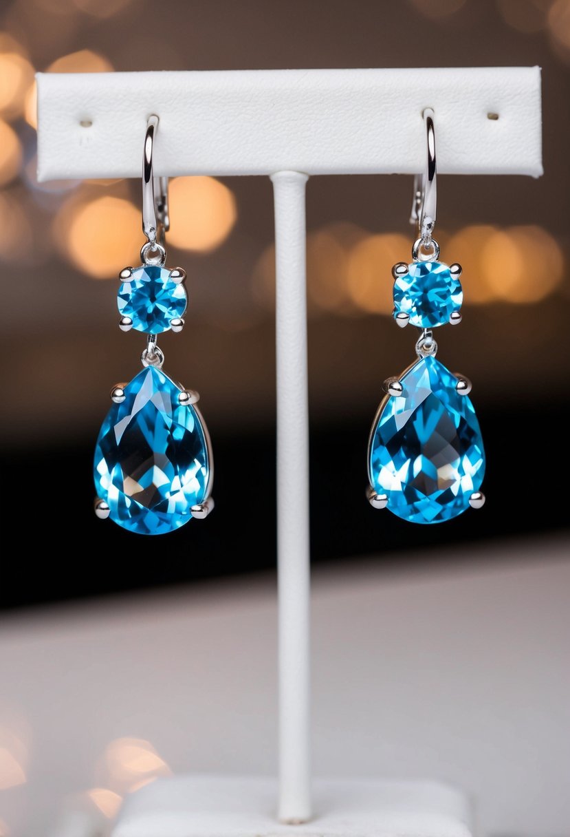 A pair of blue topaz dangle earrings hanging delicately from a display stand, catching the light and shimmering with elegance