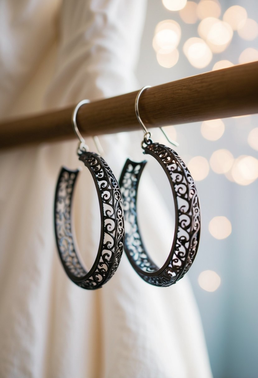 Delicate filigree hoop earrings hanging against a backdrop of a strapless wedding dress