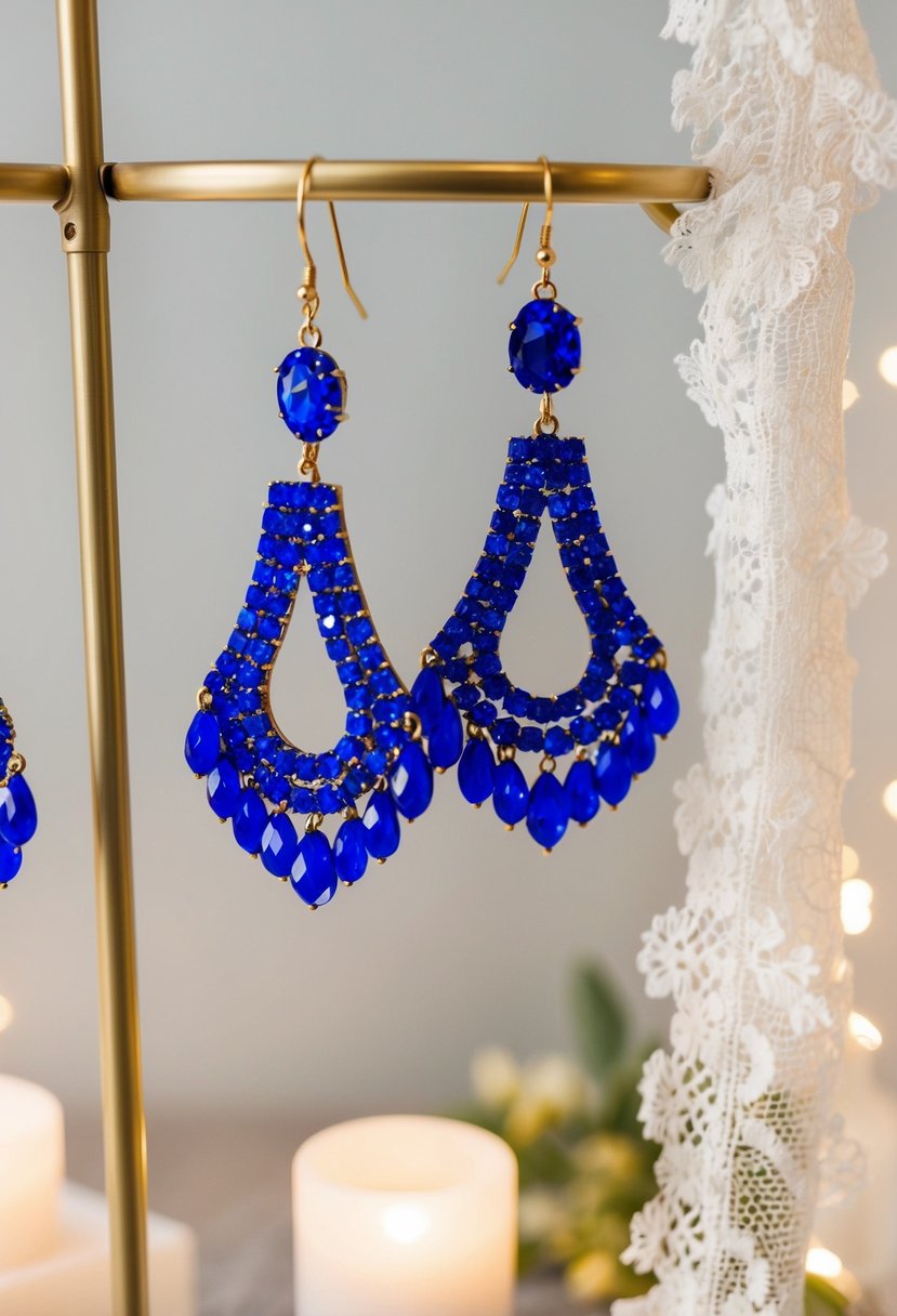 Vibrant blue chandelier earrings dangling from a display stand, surrounded by soft lighting and delicate lace fabric