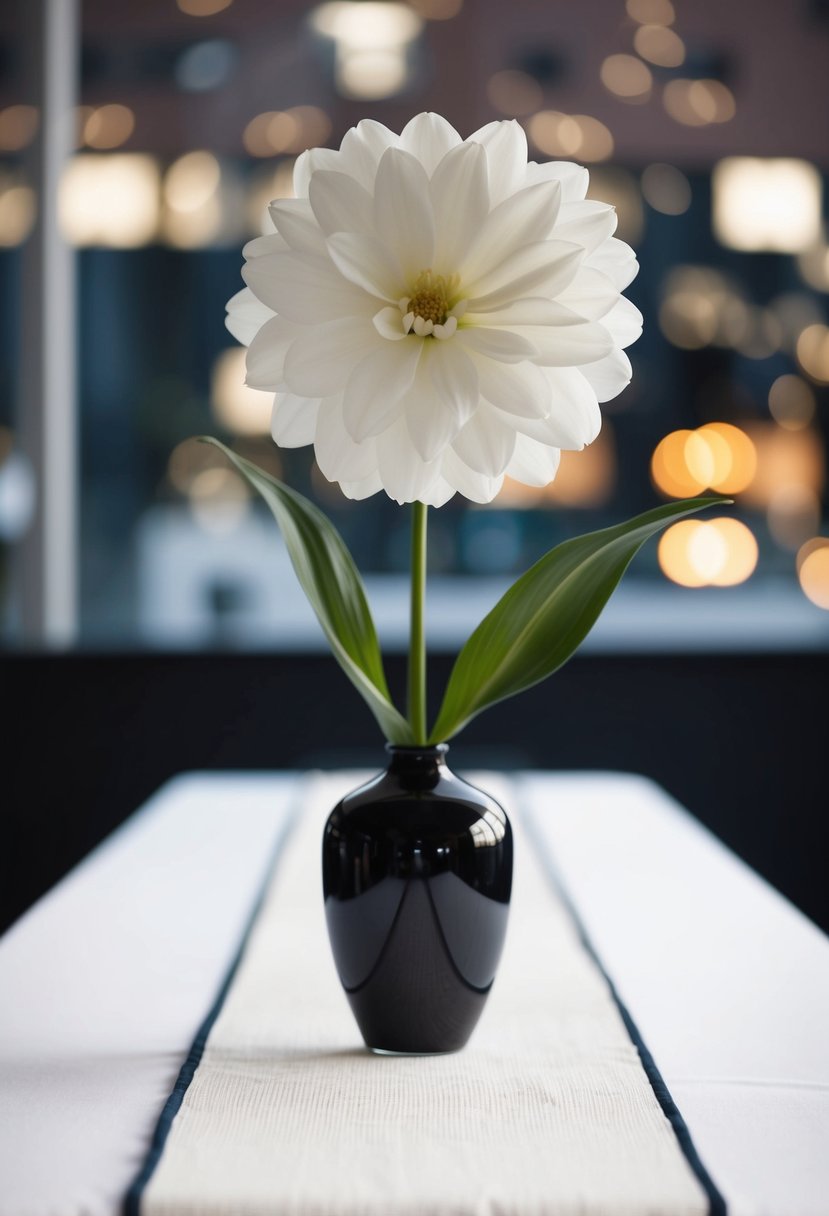 A single large bloom in a sleek vase atop a simple white table runner