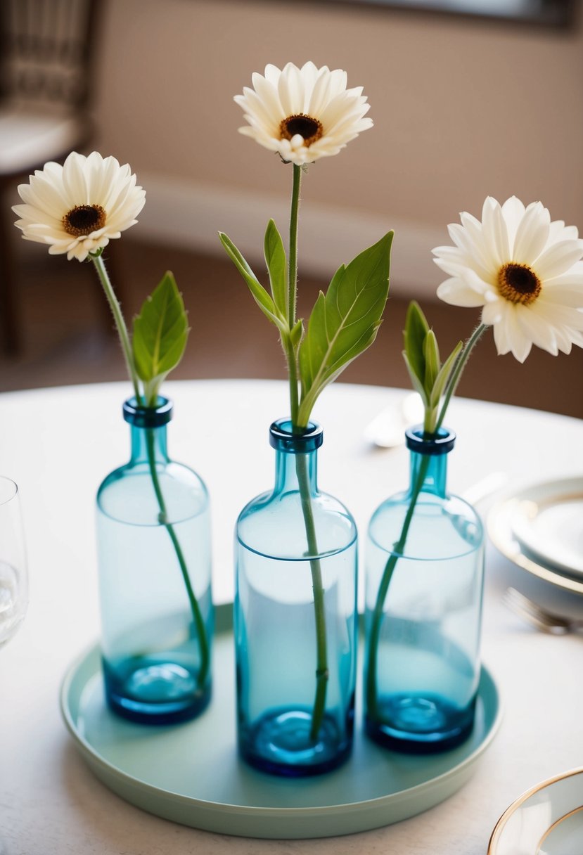 Three delicate bud vases, each holding a single flower, arranged in a charming centerpiece on a round table