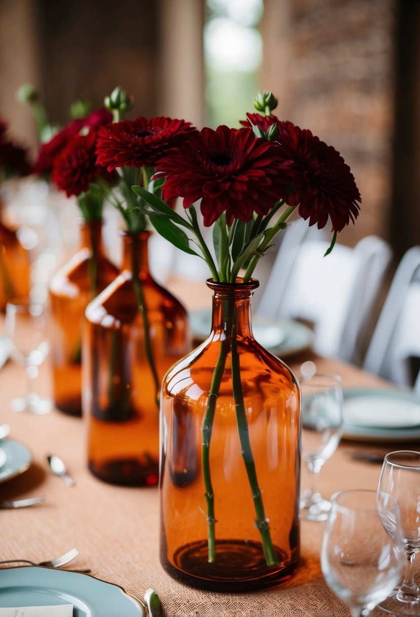 Amber glass vases hold deep red flowers, creating a romantic wedding table centerpiece