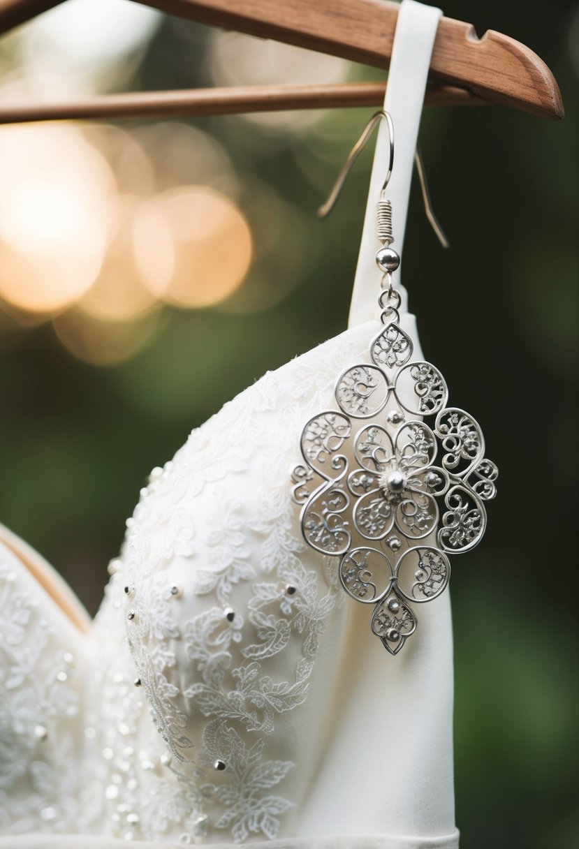 A delicate silver filigree earring hangs next to a strapless wedding dress, capturing intricate beauty