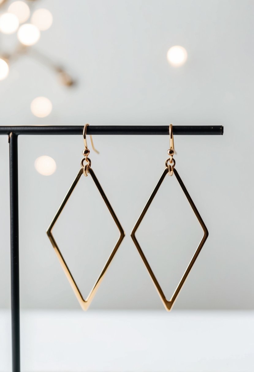 A pair of modern geometric dangler earrings displayed on a minimalist white background with soft lighting